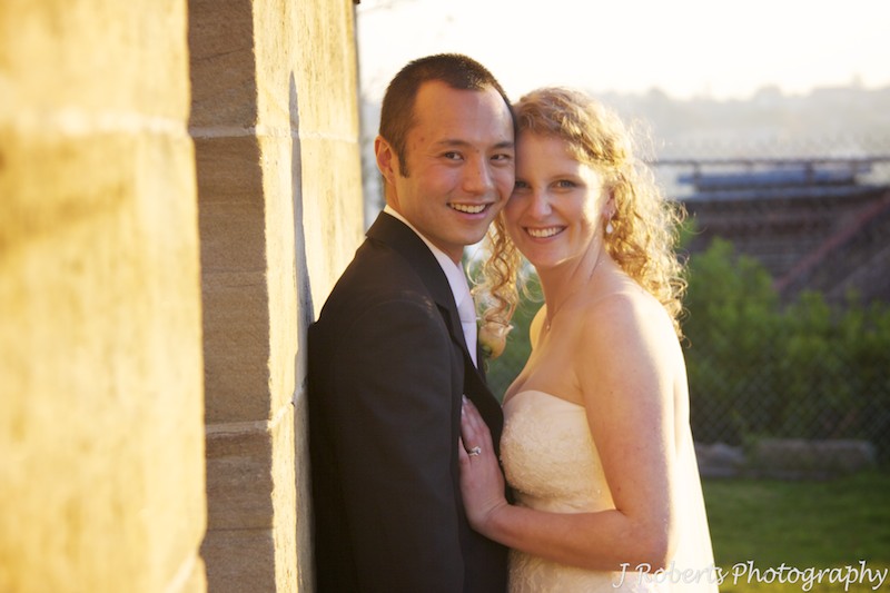 Couple next to sandstone wall - wedding photography sydney